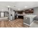 Modern kitchen with stainless steel appliances, dark wood cabinets, and a breakfast bar at 391 Begonia Ct, Kissimmee, FL 34759