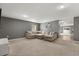 Comfortable living room with a large sectional sofa and neutral decor, perfect for relaxation at 391 Begonia Ct, Kissimmee, FL 34759