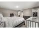 Comfortable main bedroom featuring a bed, a crib, dresser, walk-in closet, and ensuite bathroom at 391 Begonia Ct, Kissimmee, FL 34759