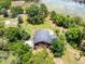 Aerial view of a wooded property featuring a house and backyard swimming pool at 4055 State Road 11, Deland, FL 32724