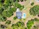 Aerial view of a wooded property featuring a house and backyard swimming pool at 4055 State Road 11, Deland, FL 32724