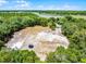 Aerial view showcasing a large open area with lush greenery, trampoline, and storage buildings at 4055 State Road 11, Deland, FL 32724