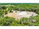 Expansive aerial view of property featuring outbuildings, open land, and mature trees at 4055 State Road 11, Deland, FL 32724