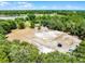 Aerial view of large open area surrounded by lush green vegetation, outbuildings, and trampoline at 4055 State Road 11, Deland, FL 32724