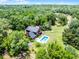 Aerial shot of house surrounded by trees with a pool at 4055 State Road 11, Deland, FL 32724