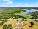 Scenic aerial view of the vast property, featuring a serene lake and lush greenery at 4055 State Road 11, Deland, FL 32724