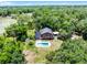 Aerial shot of house surrounded by trees with a pool at 4055 State Road 11, Deland, FL 32724