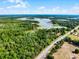 Extensive property showcasing lush greenery, tranquil lake, and road access, perfect for a buyer at 4055 State Road 11, Deland, FL 32724
