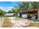View of a barn and adjacent greenhouse, perfect for a variety of farm activities at 4055 State Road 11, Deland, FL 32724