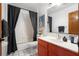 Bathroom showcasing black and white tile floors, orange vanity and a shower with black curtain at 4055 State Road 11, Deland, FL 32724
