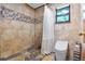 Beautifully tiled bathroom with a walk-in shower, modern toilet, and natural light at 4055 State Road 11, Deland, FL 32724