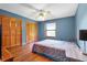 Bedroom featuring hardwood floors, ceiling fan, closet and a bright window view at 4055 State Road 11, Deland, FL 32724