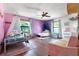 Colorful bedroom with hardwood floors, decorative beds and canopies, plus sitting area with pink sofa at 4055 State Road 11, Deland, FL 32724