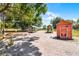Several well-maintained chicken coops offer poultry keeping, nestled beneath trees under a clear blue sky at 4055 State Road 11, Deland, FL 32724