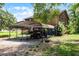 Rustic two-story home with a metal carport, an off-road vehicle, and free-range chickens at 4055 State Road 11, Deland, FL 32724