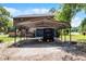 Rustic two-story home with a metal carport and free-range chickens at 4055 State Road 11, Deland, FL 32724