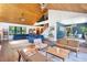 Open-concept living space with high ceilings, wood floors, comfortable seating, and seamless flow to dining and entry areas at 4055 State Road 11, Deland, FL 32724
