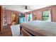 Airy main bedroom with walkout balcony, wood floors, and adjacent bathroom access at 4055 State Road 11, Deland, FL 32724