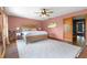 A naturally lit main bedroom featuring wood floors, ceiling fan, and a cozy atmosphere at 4055 State Road 11, Deland, FL 32724