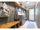 Mud room featuring built-in bench, storage, and decoratively paneled walls for added style at 4055 State Road 11, Deland, FL 32724