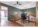 Loft-style office space featuring hardwood floors, wood railing, and black office chair at 4055 State Road 11, Deland, FL 32724