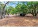 Spacious shaded property featuring mature trees, a picnic table, and an off-road vehicle at 4055 State Road 11, Deland, FL 32724