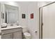 Bright bathroom featuring a sleek vanity, toilet, and glass-enclosed tiled shower at 4184 Paragraph Dr, Kissimmee, FL 34746
