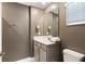 Cozy bathroom featuring neutral decor, single vanity, and a large framed mirror at 4184 Paragraph Dr, Kissimmee, FL 34746