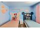 Stylized bedroom with custom headboards, each featuring unique Disney character design at 4184 Paragraph Dr, Kissimmee, FL 34746