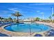 Relax by the community pool, featuring sun loungers, shady umbrellas, and a shallow water entry point at 4184 Paragraph Dr, Kissimmee, FL 34746