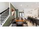Stylish dining area with modern decor, open to the kitchen and stair access to the second floor at 4184 Paragraph Dr, Kissimmee, FL 34746