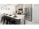 Stylish kitchen with stainless steel appliances, a breakfast bar, and modern lighting at 4184 Paragraph Dr, Kissimmee, FL 34746
