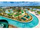Aerial view of the community lazy river winding through the property with mini-golf and lounge areas at 4184 Paragraph Dr, Kissimmee, FL 34746