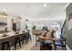 Spacious living area with a kitchen, dining area, comfortable seating, and modern design at 4184 Paragraph Dr, Kissimmee, FL 34746