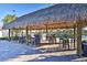 A relaxing Tiki Bar features covered tables and chairs right next to one of the many community pools at 4184 Paragraph Dr, Kissimmee, FL 34746