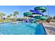 An enclosed green and blue water slide enters a refreshing pool with 3ft depth markers for safety at 4184 Paragraph Dr, Kissimmee, FL 34746
