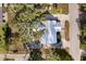 An overhead view of the home showcasing its metal roof, surrounding landscaping, and neighborhood at 465 W Lakeshore Dr, Clermont, FL 34711