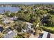 An aerial perspective of a home in a lakeside neighborhood, showcasing lush greenery and serene water views at 465 W Lakeshore Dr, Clermont, FL 34711