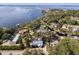 This aerial view showcases a home near a lake, surrounded by lush greenery and neighborhood charm at 465 W Lakeshore Dr, Clermont, FL 34711