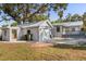 View of the backyard showing the detached garage and outdoor seating at 465 W Lakeshore Dr, Clermont, FL 34711