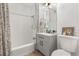 Cozy bathroom featuring tiled shower, neutral vanity, and ample lighting at 465 W Lakeshore Dr, Clermont, FL 34711