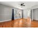 Bright bedroom featuring wood floors, a ceiling fan, and natural light from the window at 465 W Lakeshore Dr, Clermont, FL 34711