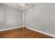 Empty bedroom featuring wood floors, a closet, and neutral decor at 465 W Lakeshore Dr, Clermont, FL 34711