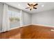 Spacious bedroom with hardwood floors, ceiling fan, and a large window at 465 W Lakeshore Dr, Clermont, FL 34711
