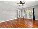 Light bedroom featuring wood floors, a ceiling fan, and natural light from the window at 465 W Lakeshore Dr, Clermont, FL 34711