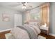 Comfortable bedroom featuring stylish decor and a plush bed with a ceiling fan at 465 W Lakeshore Dr, Clermont, FL 34711