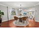Charming dining area with a round table, stylish chairs, and view into the cozy living room space at 465 W Lakeshore Dr, Clermont, FL 34711