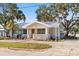 Charming home with metal roof, a garden, and mature trees at 465 W Lakeshore Dr, Clermont, FL 34711