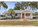 Inviting front of the home with healthy landscaping and a metal roof at 465 W Lakeshore Dr, Clermont, FL 34711