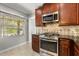 Well-equipped kitchen features stainless steel appliances, stone backsplash, and natural light at 465 W Lakeshore Dr, Clermont, FL 34711